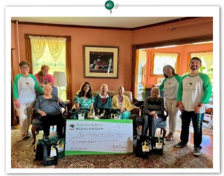 Image of IFS employees with senior residents of The Girdler House, all gathered together on a couch. 